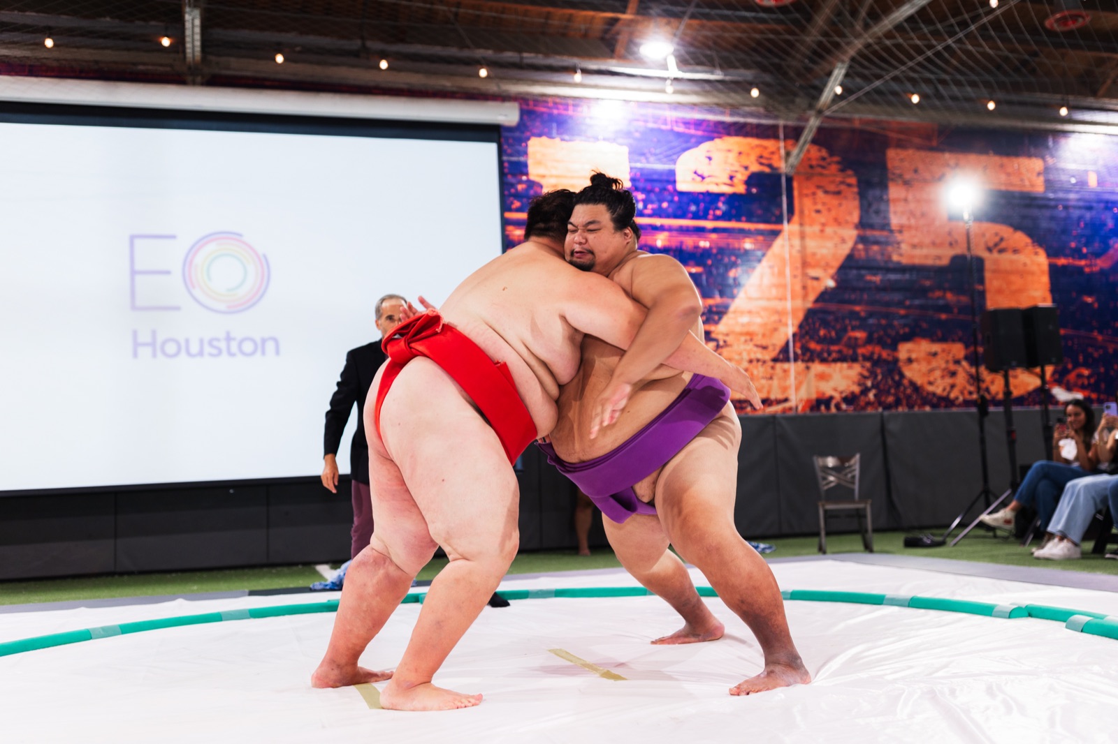 Professional sumo wrestlers grappling at the EO Houston 25th anniversary