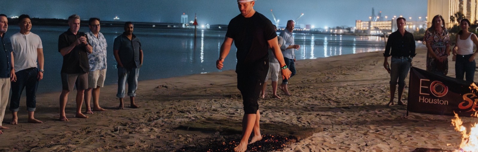 An EO Houston member walking across hot coals at the chapter retreat